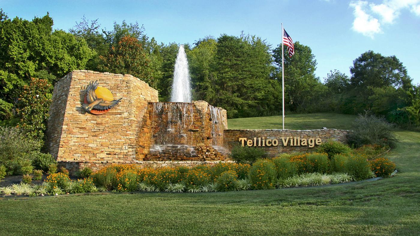 tellico village water fountain with usa flag.